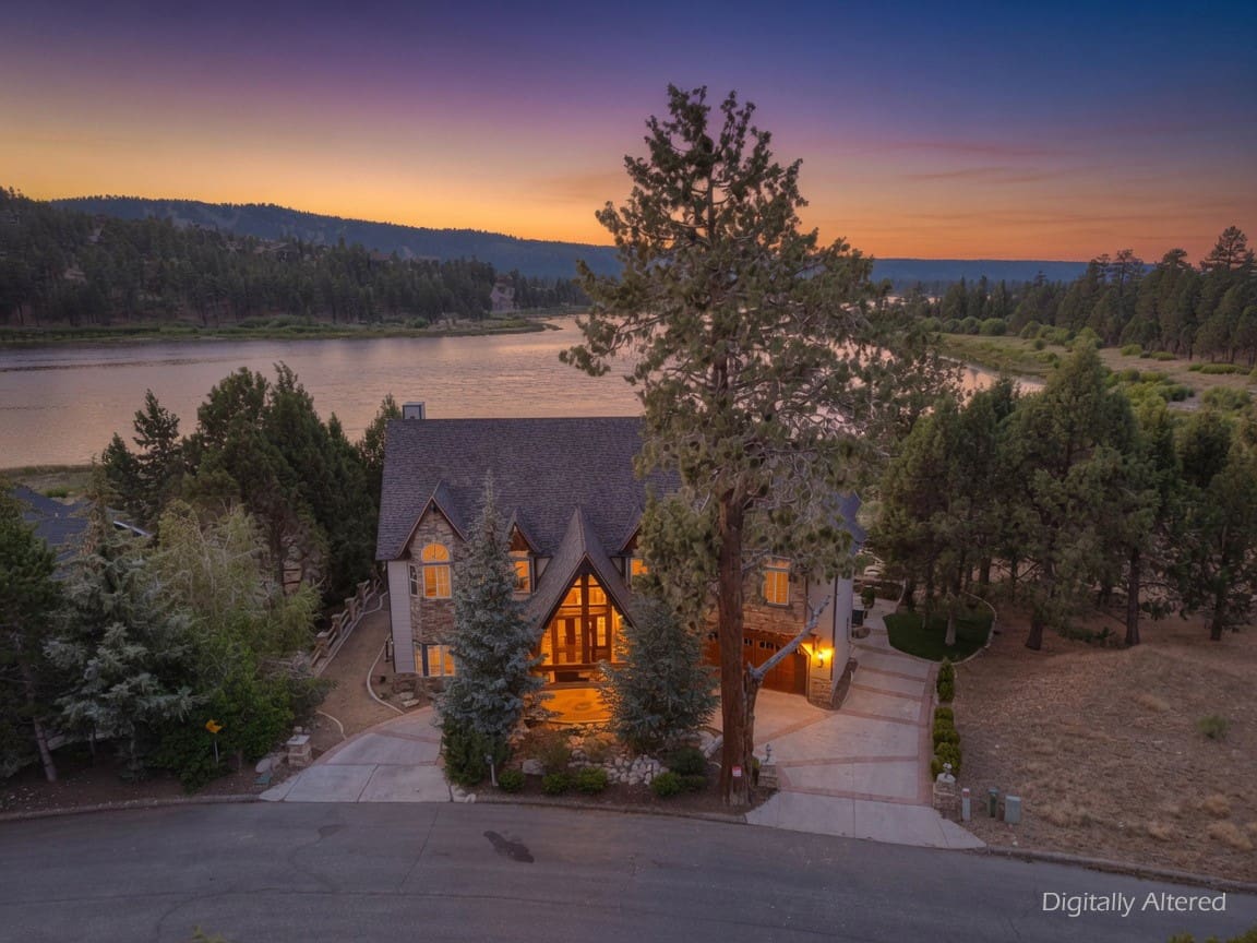 Twilight lakeside retreat framed by towering pines
