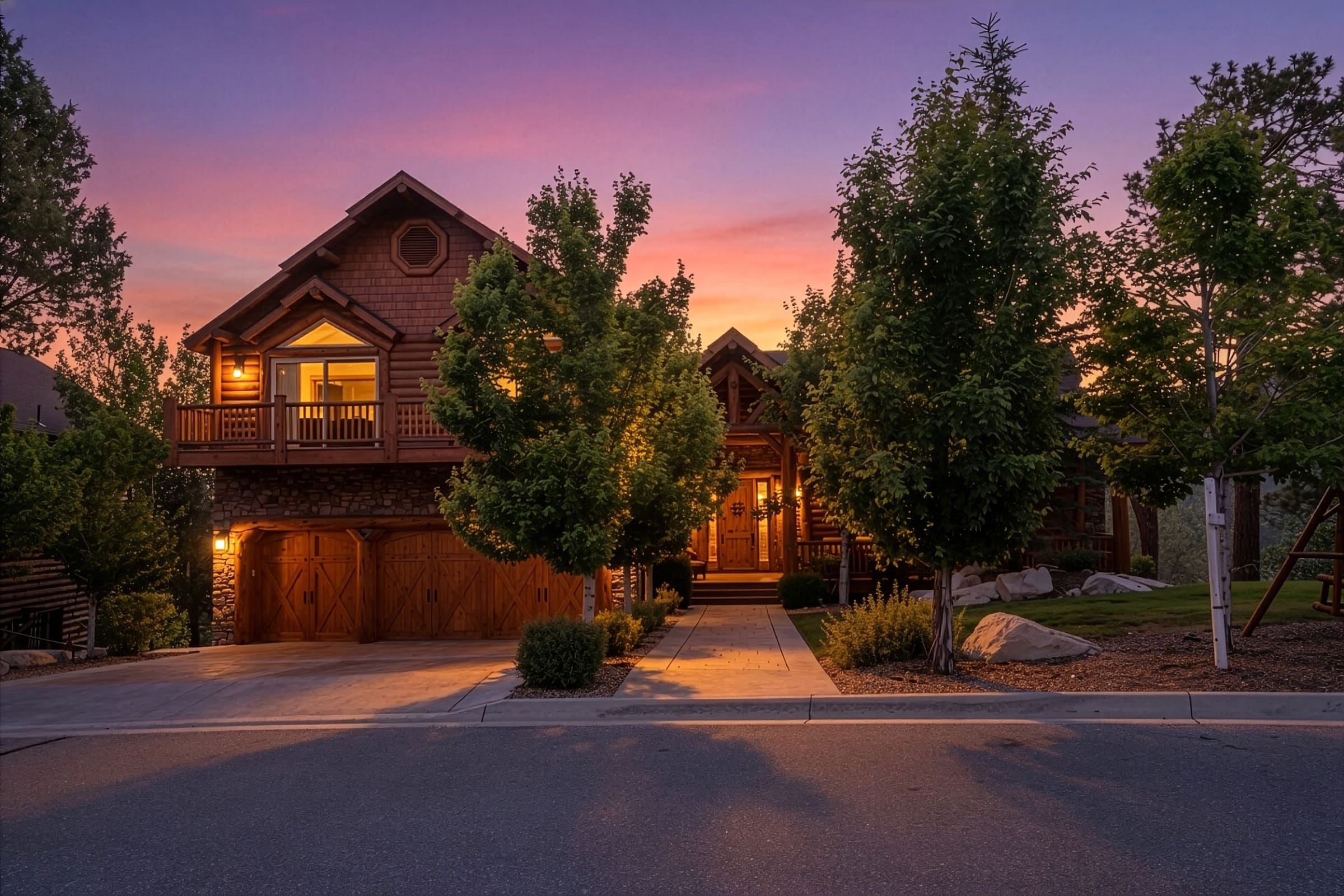 Log cabin exterior glowing under a vivid twilight sky