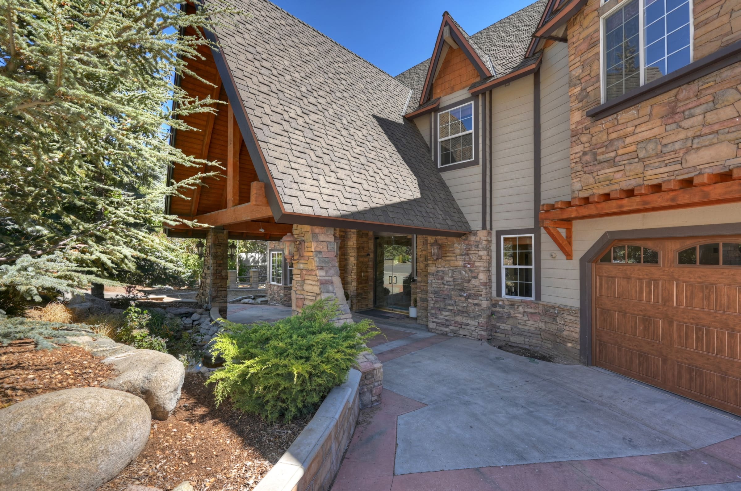 Stone-accented entrance with dramatic timber-framed gable roof