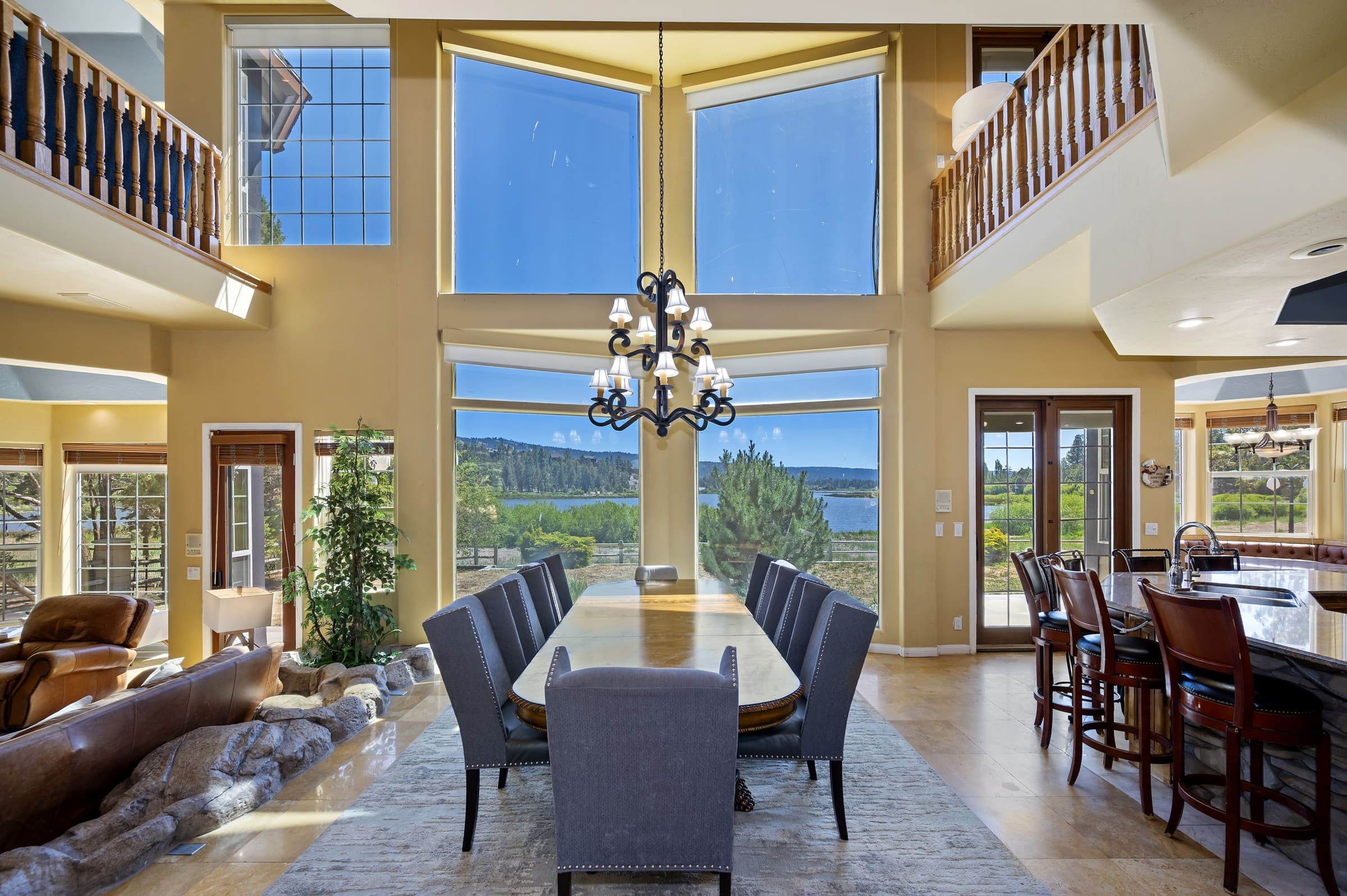 Soaring two-story windows frame lake and mountain views