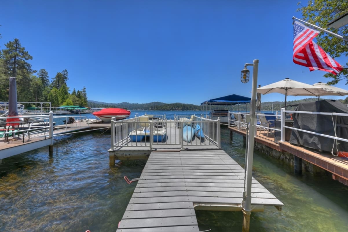 Private lakefront dock with boat slip and mountain views