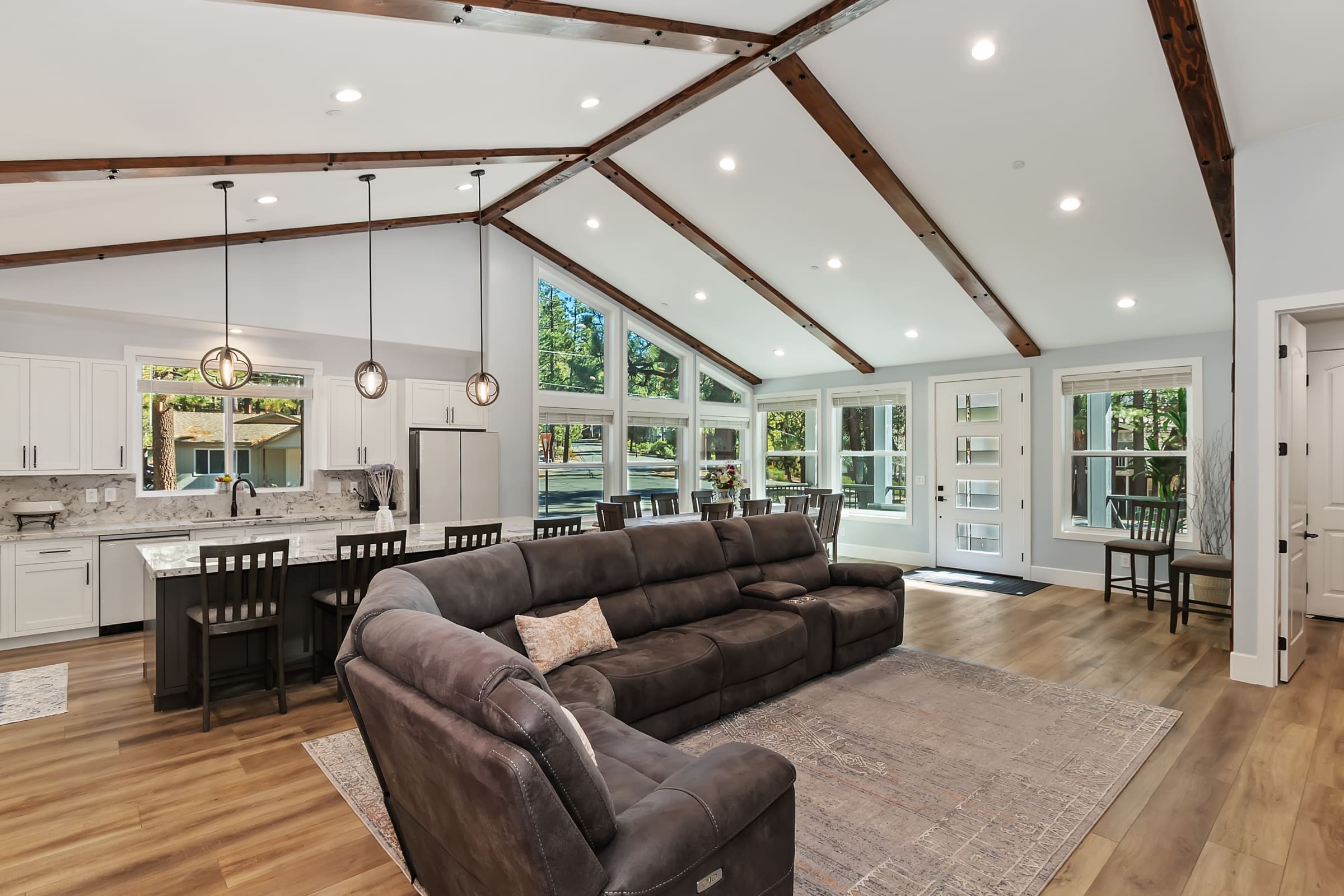 Vaulted beamed ceilings unite open-concept kitchen and living space