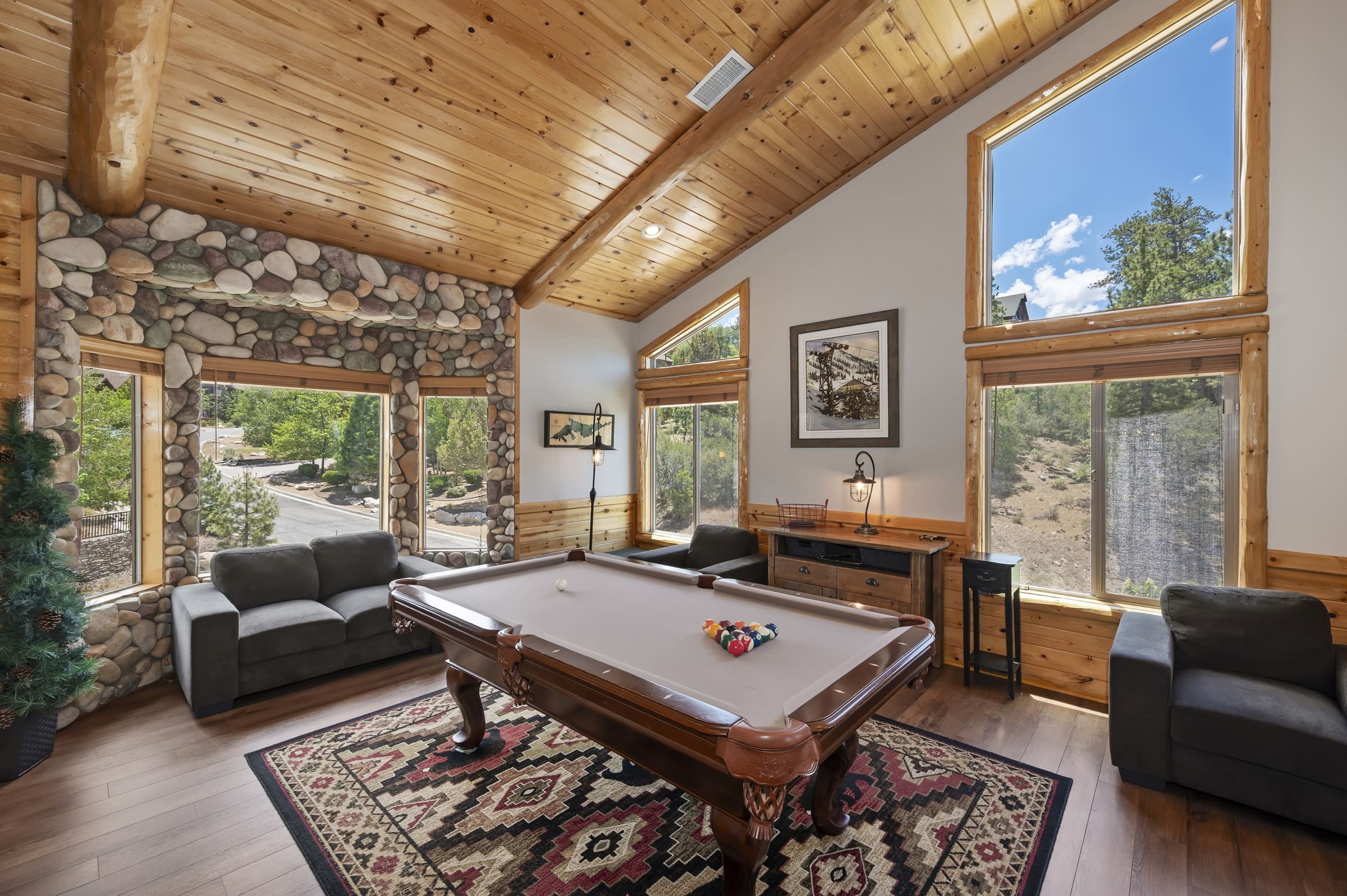 Cozy game room with pool table and stone accents