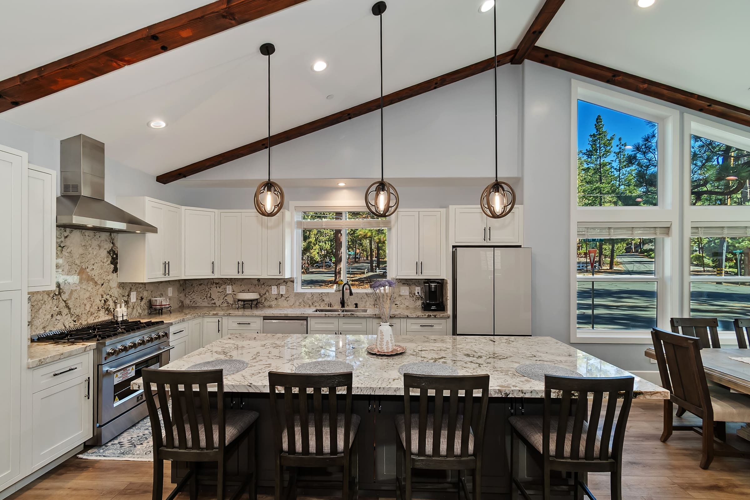Vaulted-beam kitchen with granite island seating for six