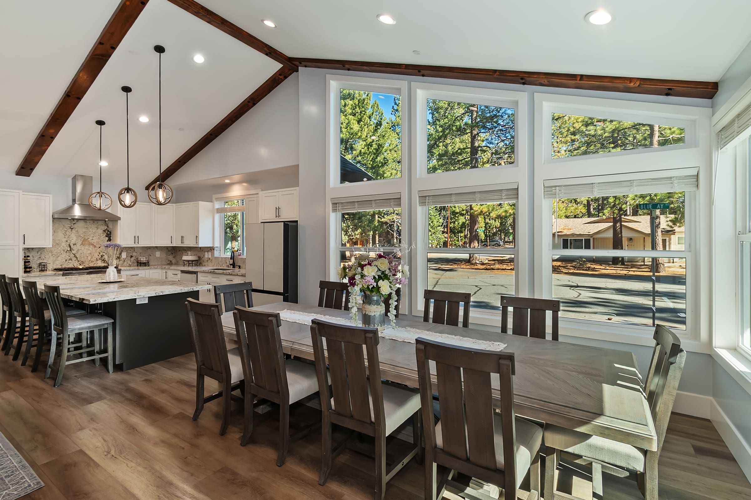 Vaulted beams and towering windows frame tree-lined views