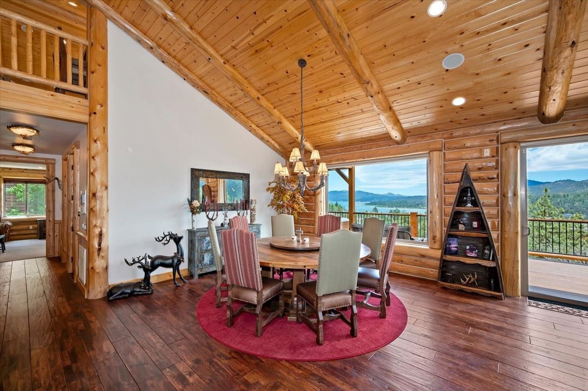 Log-cabin dining room with panoramic lake and mountain views