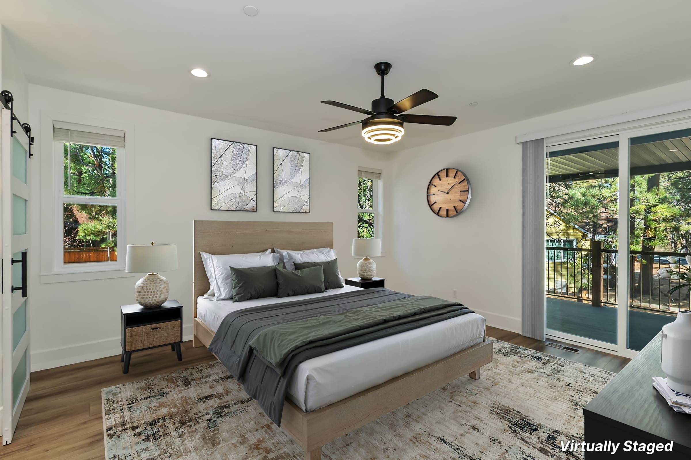 Primary bedroom with private balcony access and wooded views