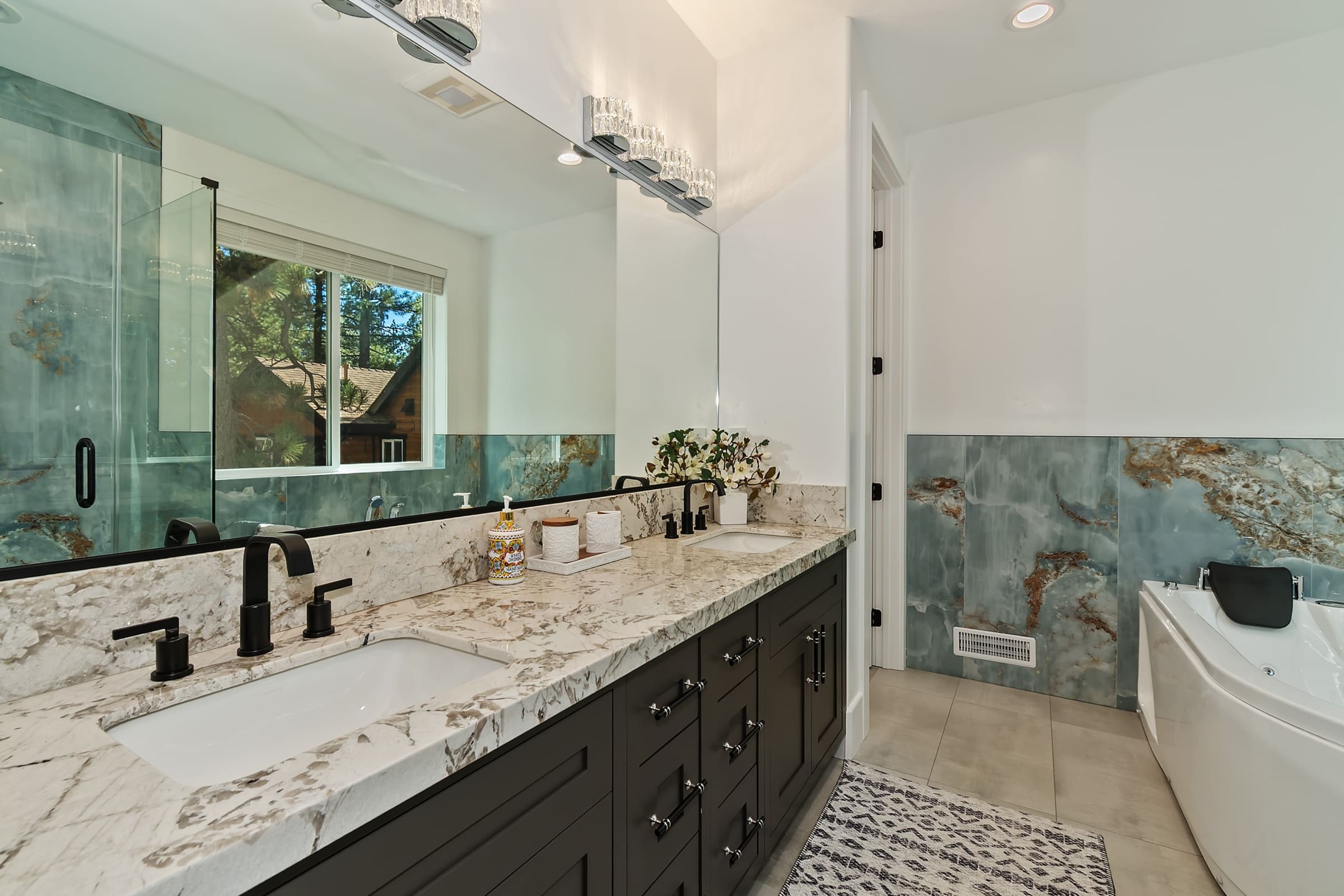 Double vanity with waterfall marble and blue-veined stone accents