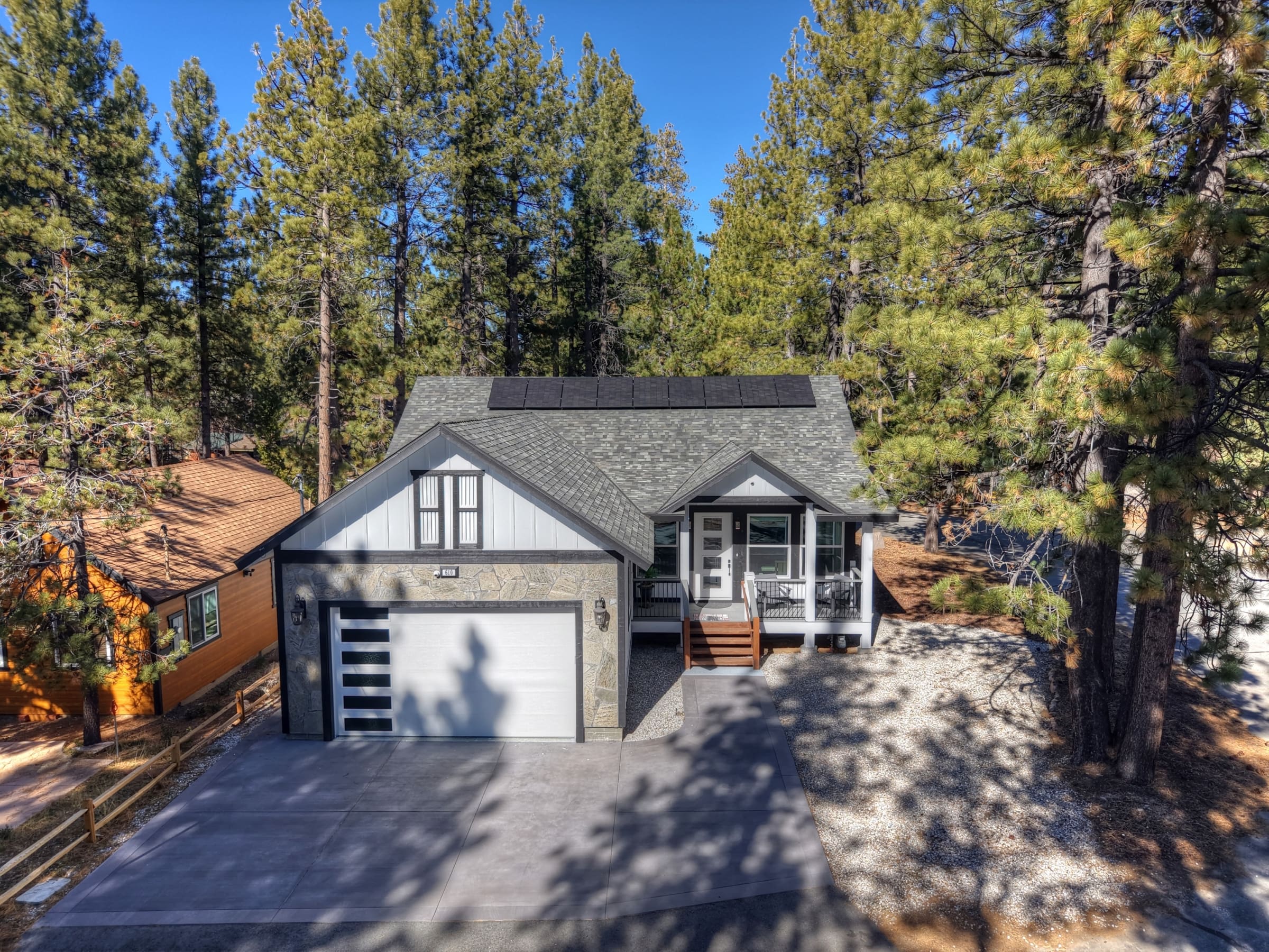 Solar-topped mountain cabin nestled among towering pines