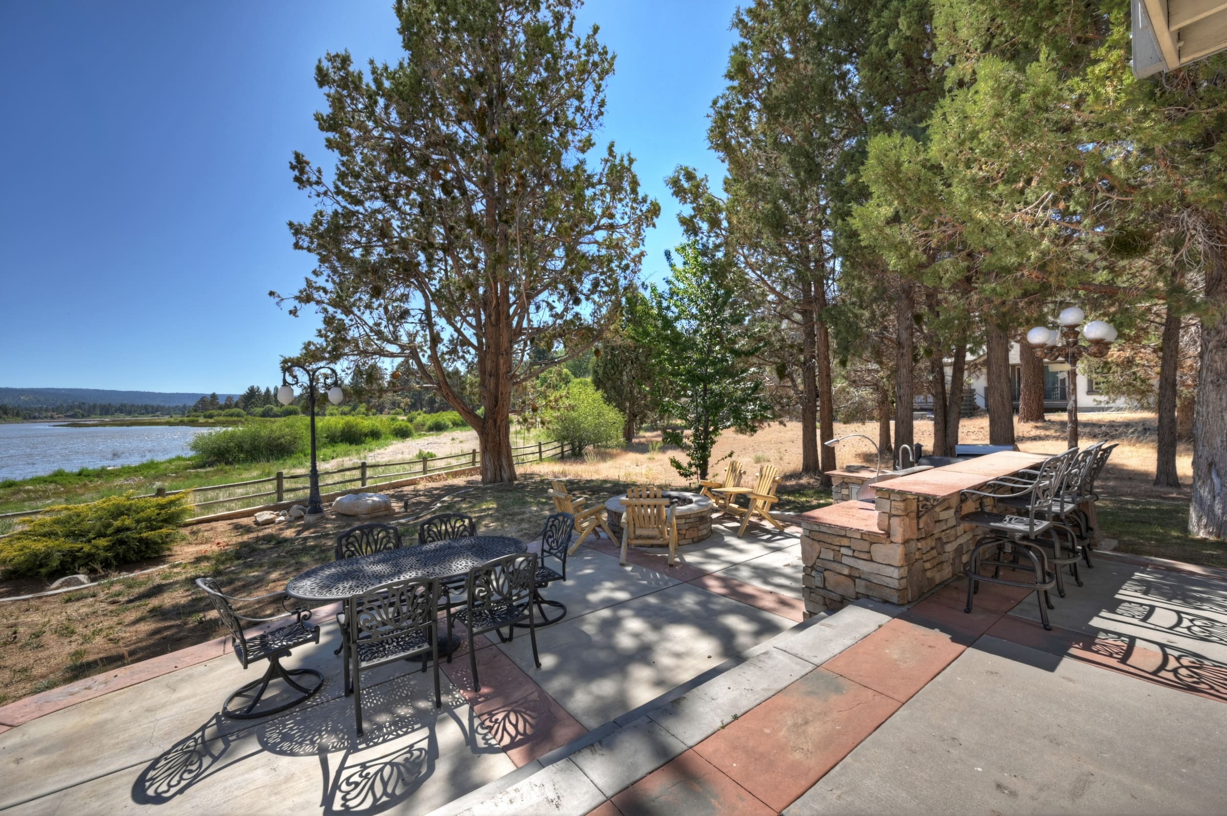 Lakeside patio with outdoor kitchen and fire pit