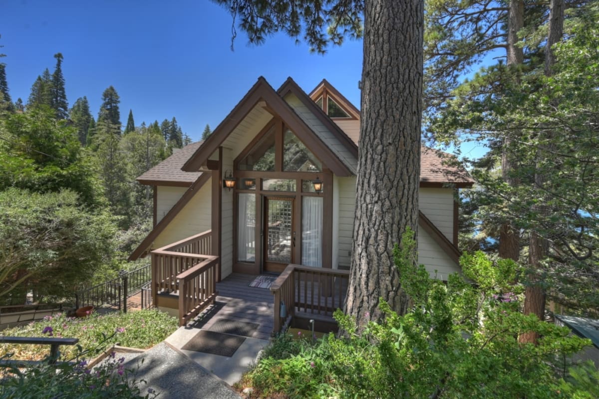 Dramatic A-frame entrance tucked among towering pines