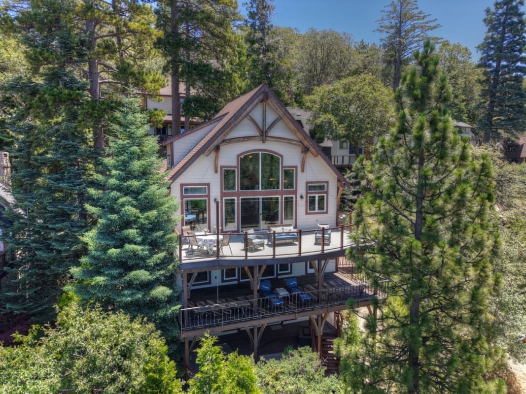 Timber-frame A-line chalet with tiered decks nestled among pines