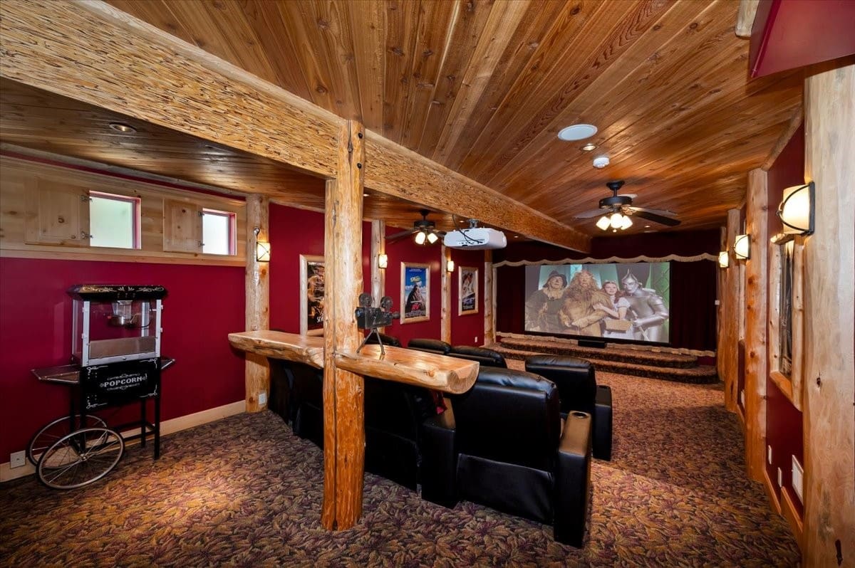 Rustic log-beam home theater with vintage popcorn cart
