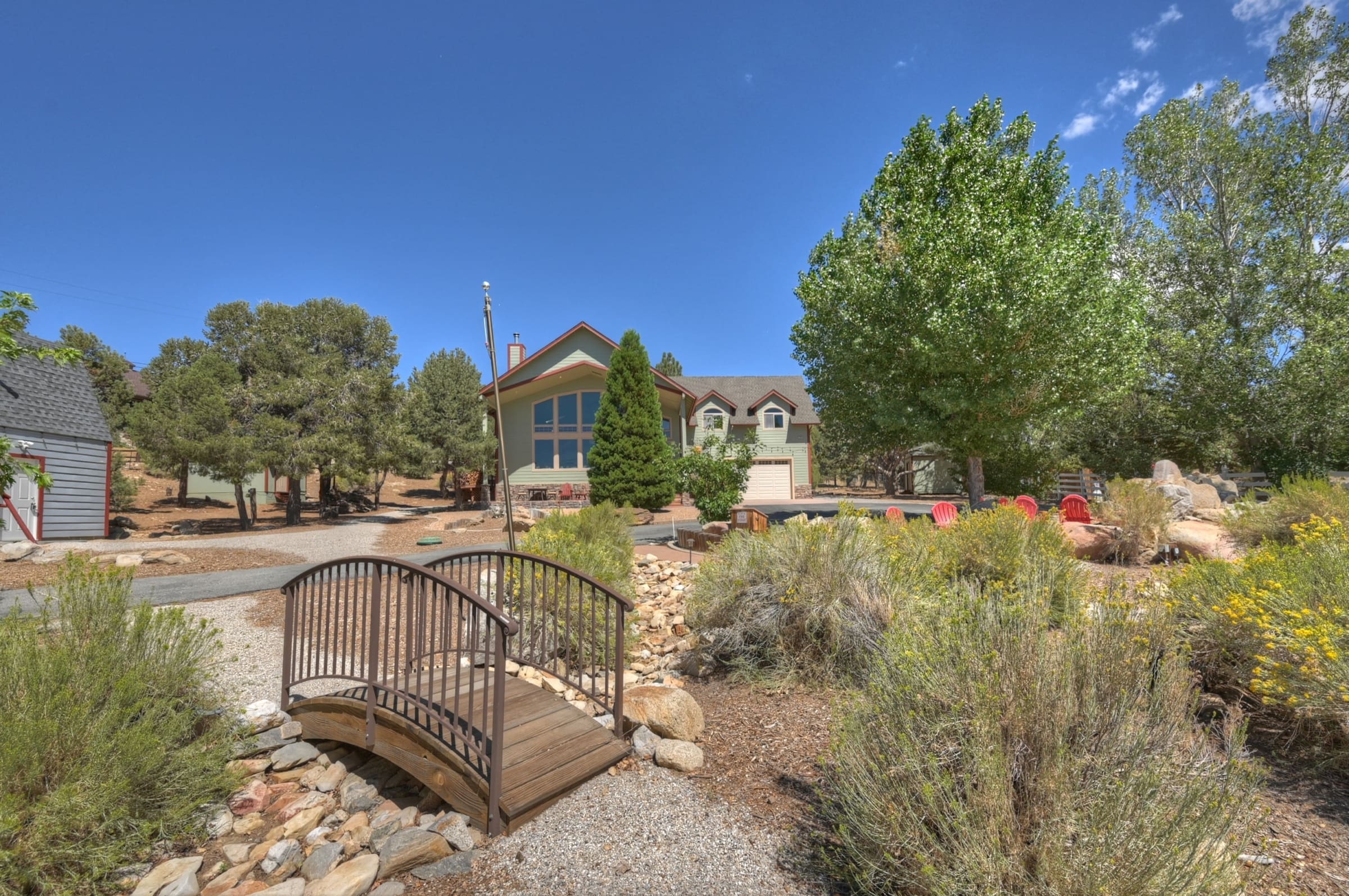 Charming footbridge over a rock-lined dry creek bed