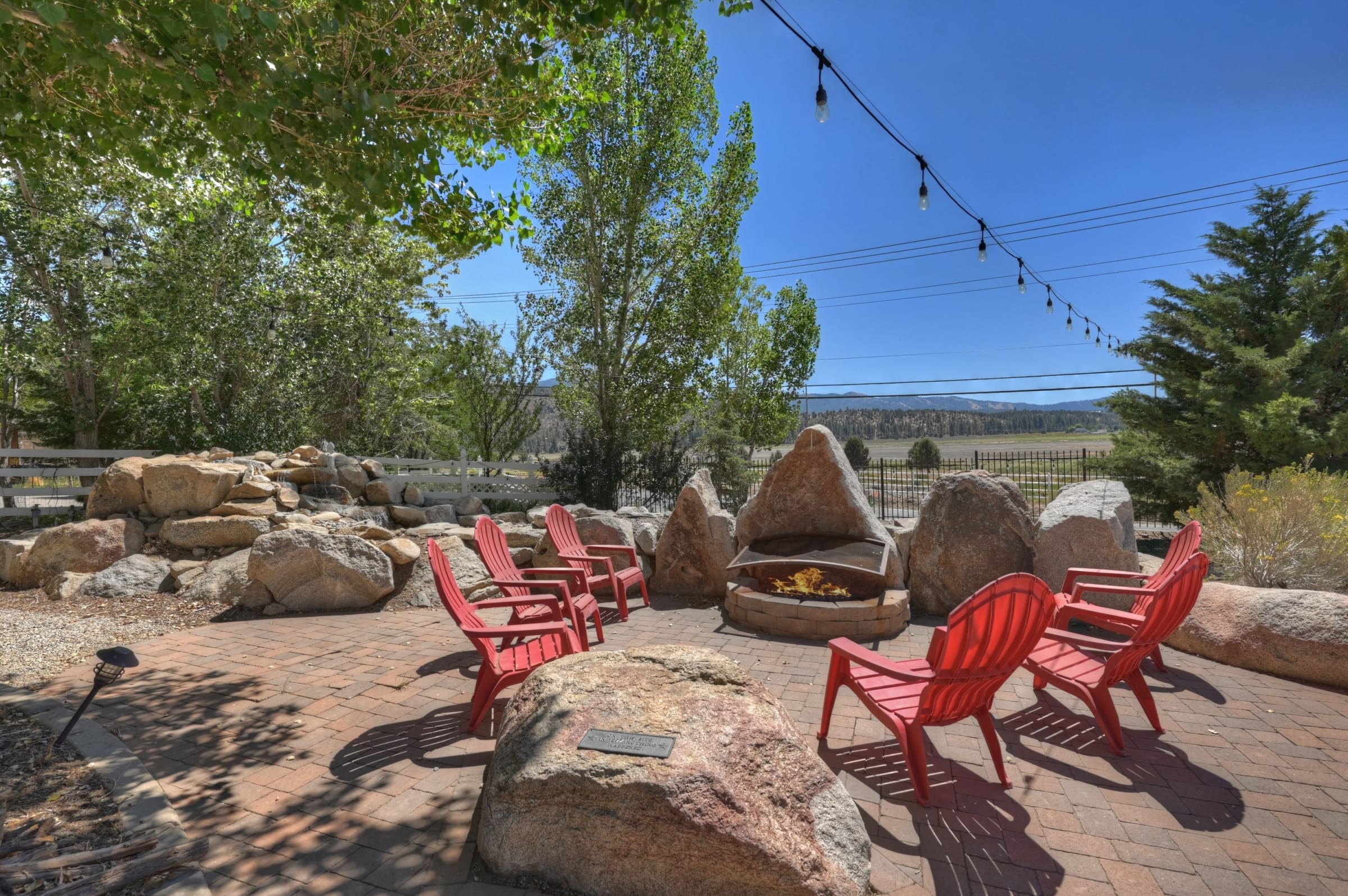 Boulder-lined patio with fire pit and mountain views