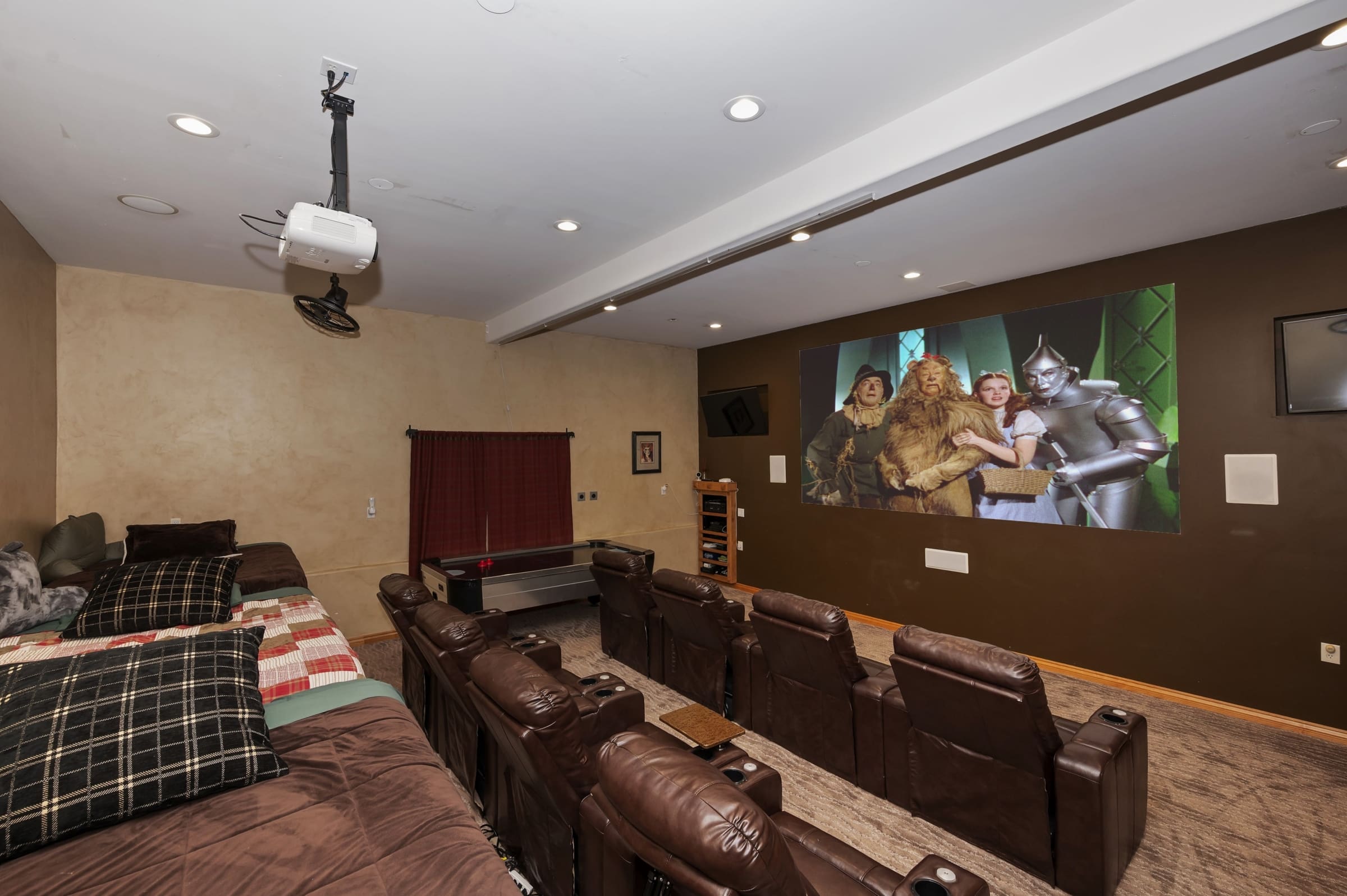 Private home theater with tiered leather recliners and big screen