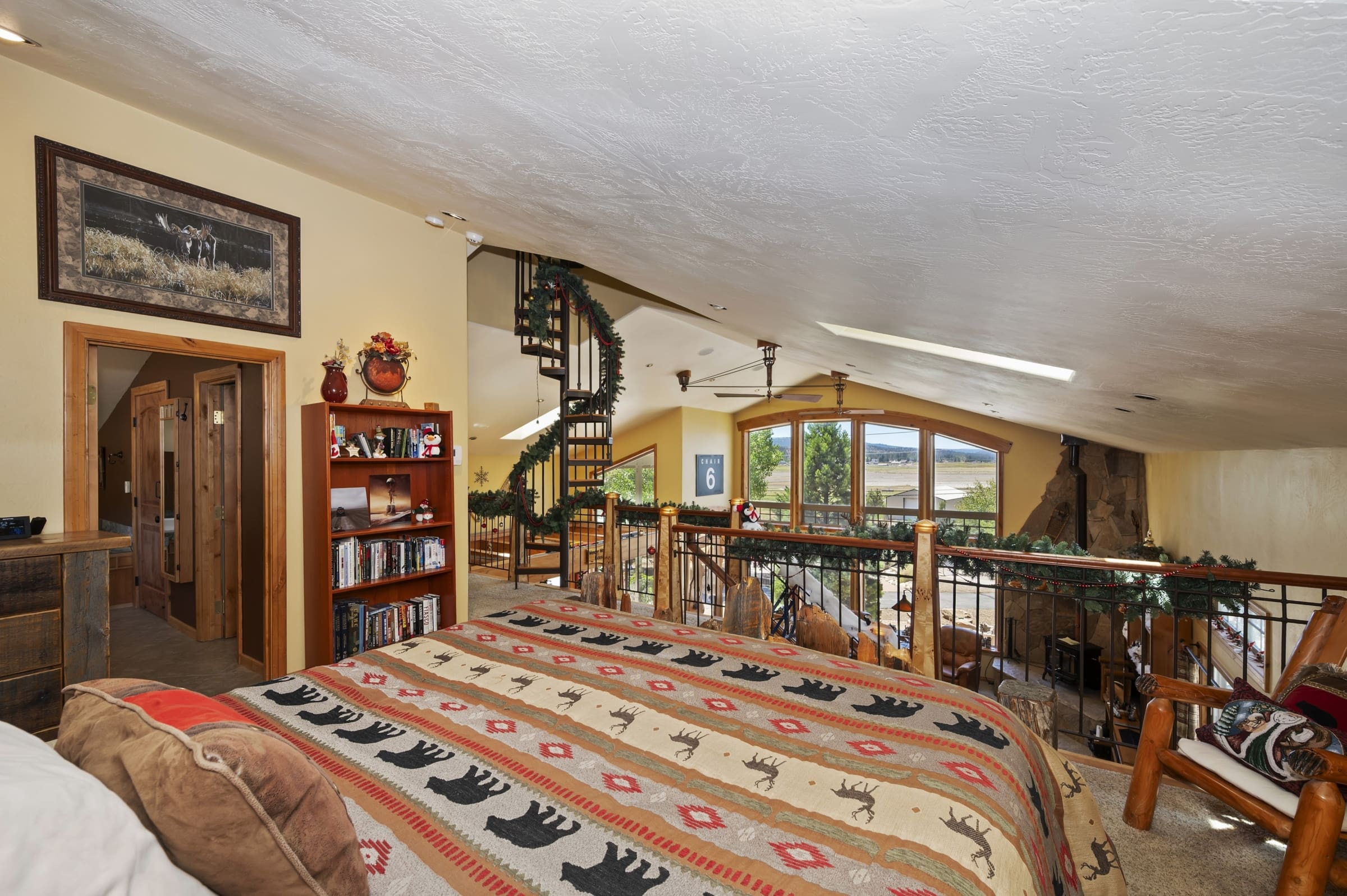 Loft bedroom with spiral staircase and valley views