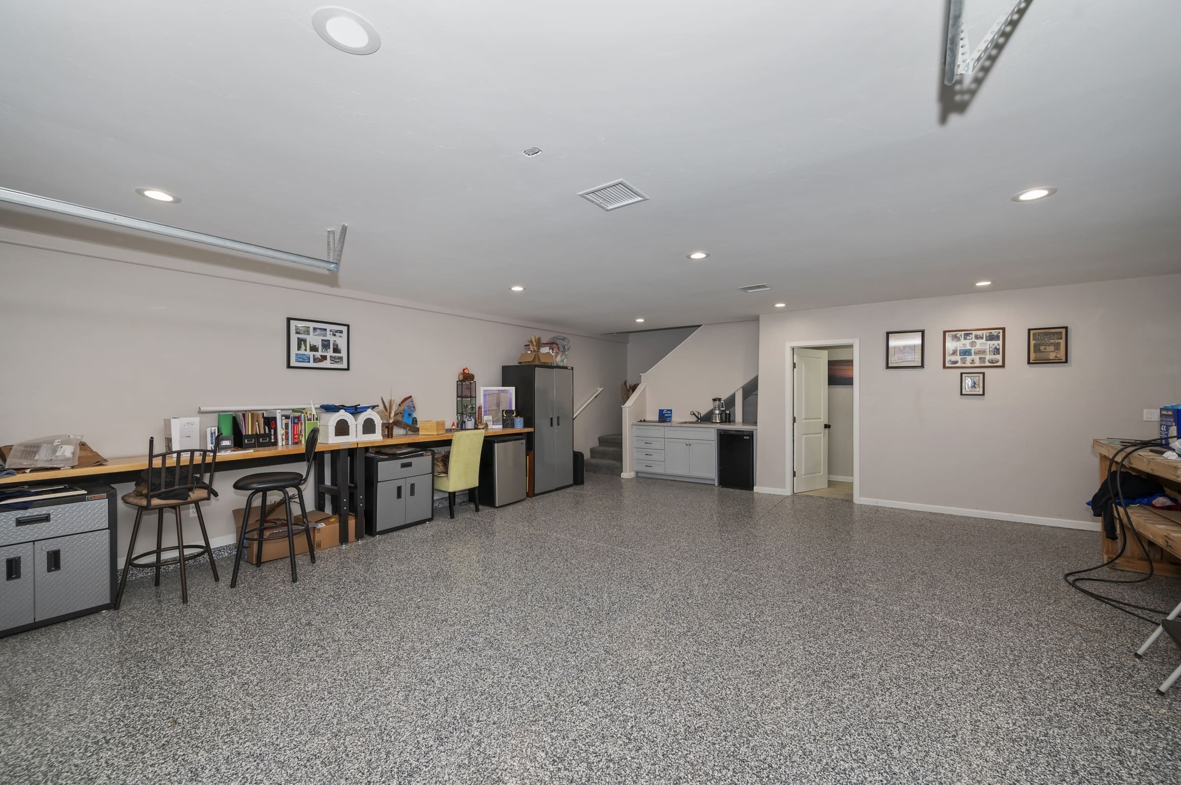 Finished basement workshop with epoxy floor and built-in bar